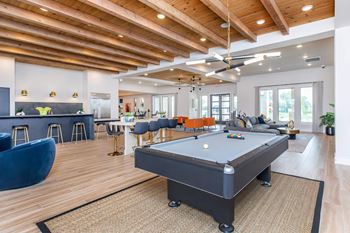 Spacious clubhouse with billiards table and open concept design